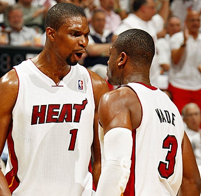 Chris Bosh (left) celebrates with Dwyane Wade as the Heat make short work of the Knicks in their series-clinching win. (Getty Images)