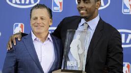 Irving accepts his Rookie of the Year trophy with Cavs owner Dan Gilbert.