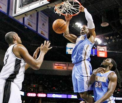 New Nugget Andre Iguodala throws down two of his 11 points in a tuneup against the Spurs.  (US Presswire)