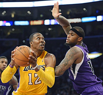 Dwight Howard, shooting against Sacramento's DeMarcus Cousins, finishes with 19 points, 12 rebounds and four blocks. (US Presswire)