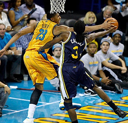 Davis totals eight points, six boards and two blocks -- here vs. Utah's DeMarre Carroll -- before exiting with a concussion. (AP)