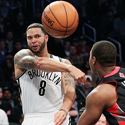Deron Williams scores 19 points and adds nine assists for the Nets in their first game in Brooklyn. (AP)
