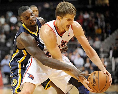 Lance Stephenson defends Kyle Korver, who later scores eight consecutive points during Atlanta's decisive run.  (US Presswire)