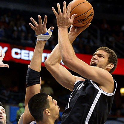 Brook Lopez contributes 14 points and 10 rebounds to the Nets' blowout win against the Magic. (AP)