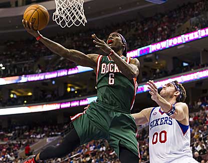 Milwaukee's Marquis Daniels goes up for two point past the 76ers' Spencer Hawes. (US Presswire)