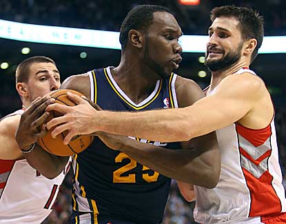 Utah's Al Jefferson, center, battles with Linas Kleiza and Jonas Valanciunas in the Jazz's win. (US Presswire)