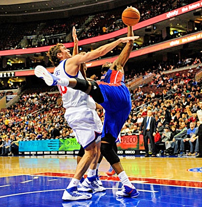 Greg Monroe (right), who scores 19 points and grabs 18 boards, fights for the ball with 76ers center Spencer Hawes. (US Presswire)