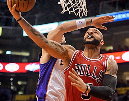 Chicago's Carlos Boozer makes 11 of 20 shots, dominating inside as the Bulls scored 50 points in the paint. (US Presswire)