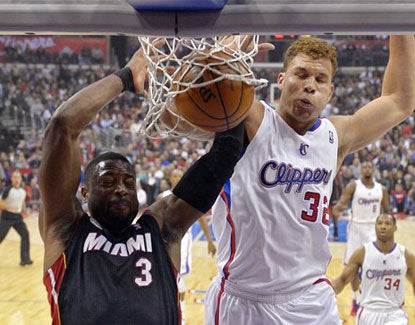 The Clippers' Blake Griffin dunks on Miami's Dwyane Wade. Griffin scores 20 points and grabs 14 rebounds. (AP)