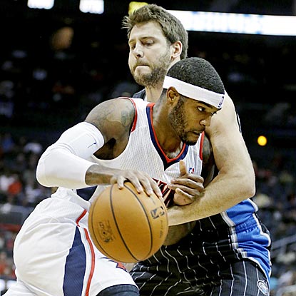 Josh Smith and the road-weary Hawks muscle their way past Josh McRoberts and the struggling Magic.  (AP)