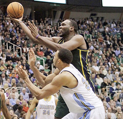 Al Jefferson (28 points) and the Jazz overcome a 16-point hole to survive the Nuggets and keep their perfect home mark intact. (AP)