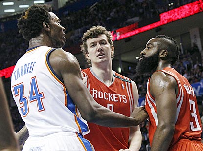 Omer Asik (center) diffuses some tension between Hasheem Thabeet (34) and James Harden, who were teammates briefly in the fall. (AP)