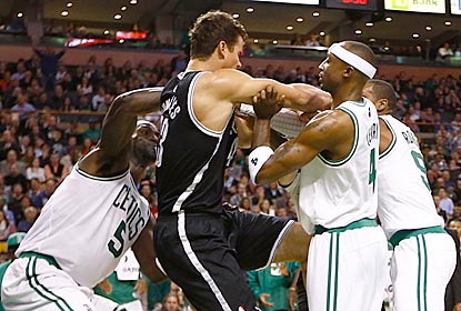 Kris Humphries (center) incurs the wrath of Rajon Rondo (far right) for his hard foul on Kevin Garnett (left).  (Getty Images)