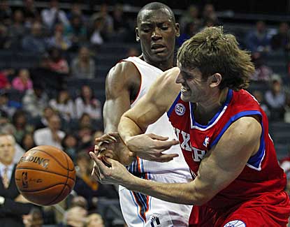 Charlotte's Bismack Biyombo, left, battles with the 76ers' Spencer Hawes on Friday night. (AP)