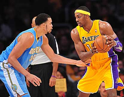 Lakers center Dwight Howard looks for an opening against Denver's JaVale McGee. (US Presswire)