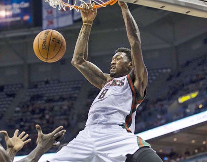 Larry Sanders jams home two of his 18 points against the Celtics. The Bucks big man also grabs 16 boards. (US Presswire)