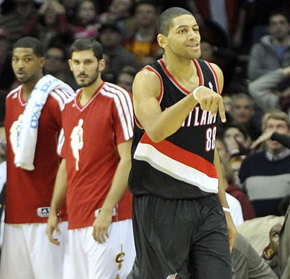 Nicolas Batum quiets the crowd after draining a winning 3 in double overtime to seal Portland's win. (US Presswire)