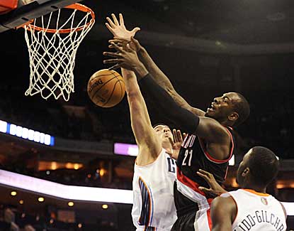 Blazers center J.J. Hickson battles for a rebound with Charlotte's Byron Mullens on Monday. (US Presswire)