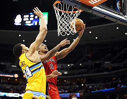 Toronto guard DeMar DeRozan drives for the layup against Denver's JaVale McGee. (US Presswire)