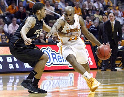 Trae Golden, driving here against Wichita State's Demetric Williams, helps spark Tennessee's offense out of dormancy.  (AP)