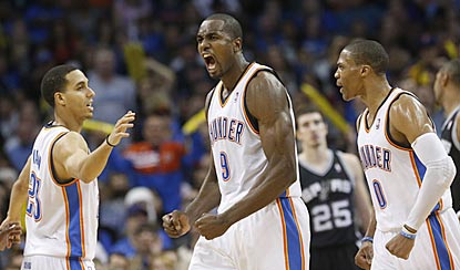 Kevin Martin (left) and Russell Westbrook (right) help Serge Ibaka celebrate one of the best games of his career.  (AP)
