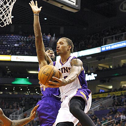 Phoenix's Michael Beasley drives past Sacramento's James Johnson while passing during the game-changing third quarter.  (AP)