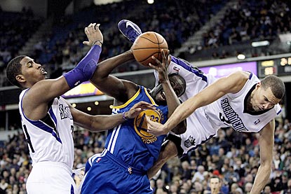 Francisco Garcia goes sidways as Kings teammate Jason Thompson tries to stop Warriors forward Draymond Green.  (US Presswire)