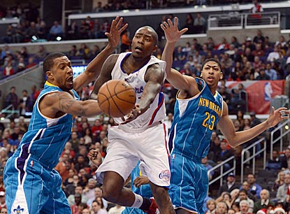 Clippers guard Jamal Crawford makes a pass while Dominic McGuire (left) and Anthony Davis try to defend.  (Getty Images)