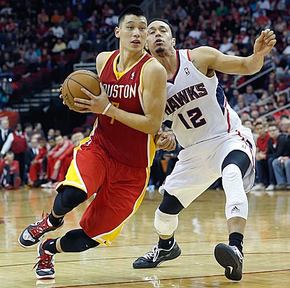 Jeremy Lin, shown blowing by John Jenkins here, contributes 16 points and eight assists for host Houston.  (Getty Images)