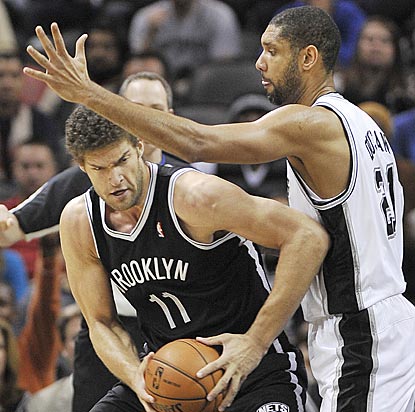 Tim Duncan and the Spurs don't give Brook Lopez and the Nets a lot of space to operate their offense.  (AP)