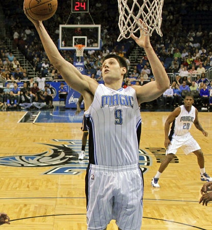 The Magic's Nikola Vucevic, who scores 16 points in the win over the Pacers, grabs one of his 15 rebounds. (AP)