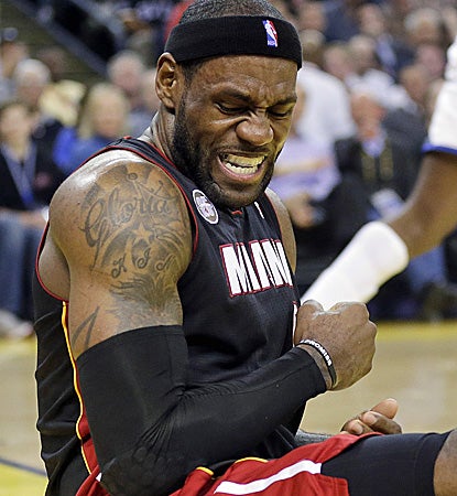 The Heat get a scare when LeBron James falls down after taking a shot against the Warriors during the first half. (AP)