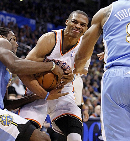 Russell Westbrook, who fights for possession of the ball, scores half of his 32 points in the opening quarter. (AP)