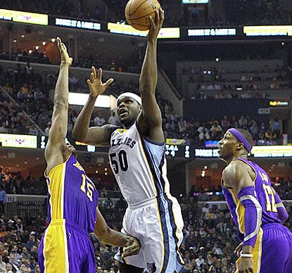 Zach Randolph drives between Metta World Peace (left) and Dwight Howard during another double-double performance.  (US Presswire)
