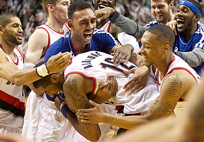 LaMarcus Aldridge gets surrounded by his teammates after finishing off a 29-point performance with a game-ending basket.  (US Presswire)