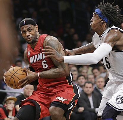 Gerald Wallace can't stop LeBron James, whose near-triple-double helps Miami beat Brooklyn for the 13th consecutive time.  (AP)
