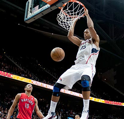 After Al Horford slams home the game's final points, the Hawks hang on to defeat the undermanned Raptors.  (US Presswire)