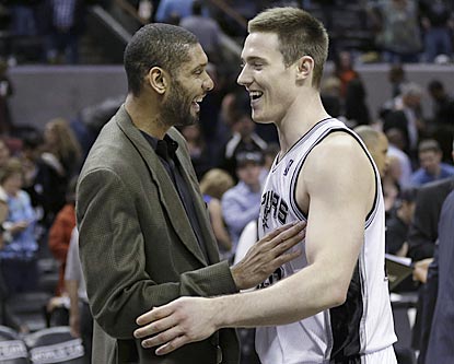 Tim Duncan congratulates Aron Baynes on his seven-point, nine-board effort during his first significant NBA playing time.  (AP)