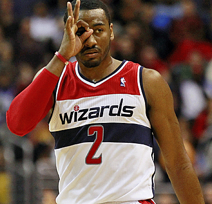 John Wall gestures to the crowd after helping the Wizards halt their four-game losing streak.  (US Presswire)