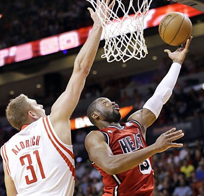 Dwyane Wade, who helps overcome the absence of Chris Bosh, finishes with 31 points and eight assists against the Rockets. (AP)