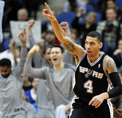 Danny Green lights up the scoreboard and excites the Spurs bench by draining eight 3s against the Wolves. (AP)