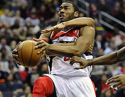 John Wall (15 points, 9 assists) will head to the line after being fouled by Keith Bogans. (US Presswire)