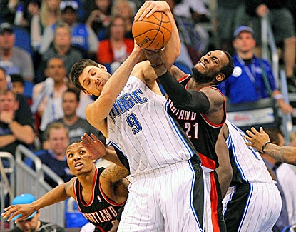 Orlando's Nikola Vucevic (left), who scores 17 points and adds 19 rebounds, battles with J.J. Hickson for the ball. (US Presswire)