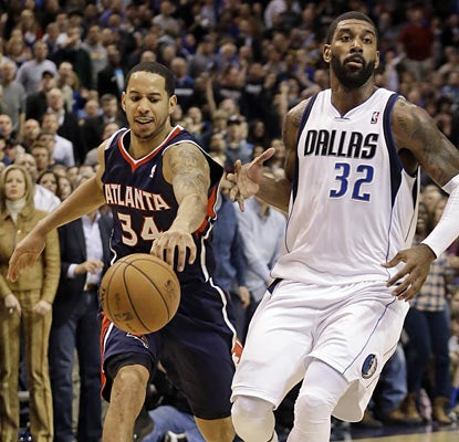 Devin Harris mugs O.J. Mayo late in the fourth, stealing a potential fast-break bucket and preserving the Hawks' lead. (AP)