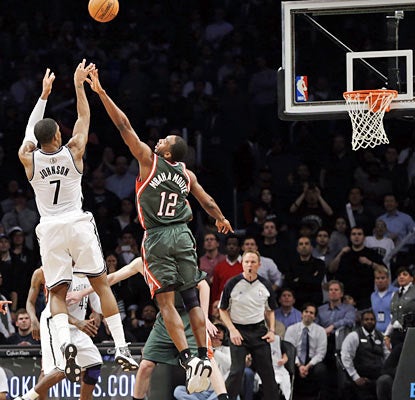 After draining a 3 that forces overtime, the Nets' Joe Johnson sinks the game-winning shot before the buzzer sounds. (AP)