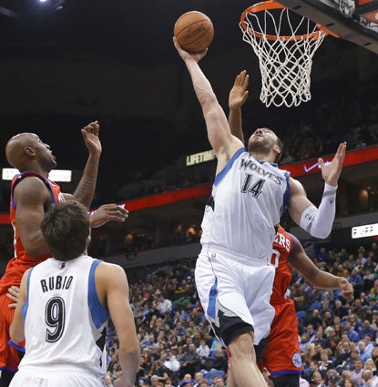 Nikola Pekovic, who scores 27 points, goes up for one of his 18 rebounds against the 76ers. (AP)
