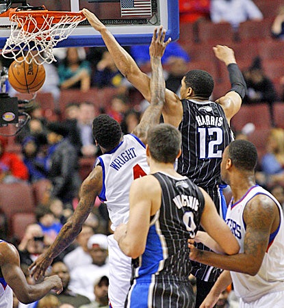 Orlando's Tobias Harris (right) dunks on Philadelphia's Dorell Wright during the Magic's win over the Sixers. (AP)