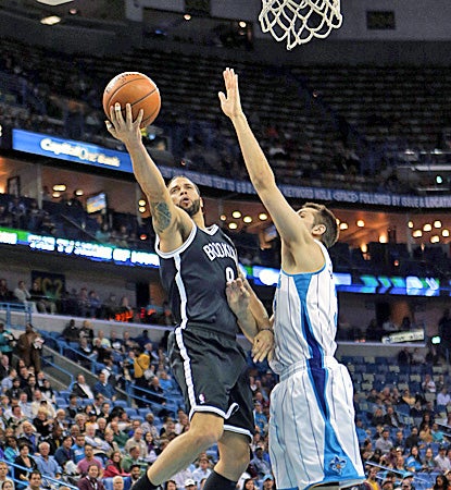 Deron Williams goes in for two of his team-high 33 points as the Nets hold on for a win against the Hornets. (AP)