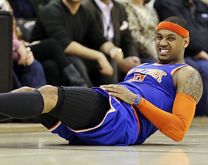 Melo stumbles in the second quarter, landing awkwardly. He exits with a right knee injury and doesn't return. (AP)