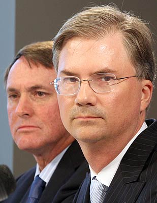 Coach Butch Davis and UNC chancellor Holden Thorp look on at the conference. (AP)